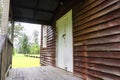 Porch of an old wooden weatherboard building.