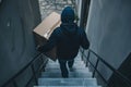 Man with hoodie stealing a package at the doorstep - AI Generated