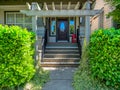 Porch with red chair and entrance of residential house