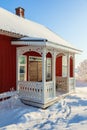 Porch on a red cottage a sunny winter day Royalty Free Stock Photo