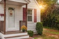 The porch of a small cozy wooden house and with yellow chrysanthemums on the threshold. USA. Maine. Home simple comfort.