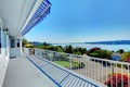 Porch with water view and grey house exterior.