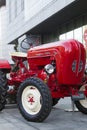 Porsche Junior tractor parked in front of a hotel
