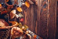 Porcini mushrooms in basket with berries and nuts on wooden table. Autumn harvest. Gathered fall crop. Space Royalty Free Stock Photo