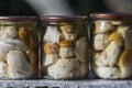 Porcini mushrooms canned in a glass jar for sale at the local market, Western Ukraine, close up