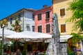 Porec Parenzo, Croatia; 7/19/2019: Colorful facades of the typical croatian houses in the old town of Porec, with umbrellas from