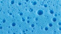 Bright Blue Sponge Surface with Numerous Small and Large Bubbles and Pores Royalty Free Stock Photo