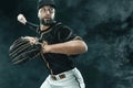 Baseball player with ball. Ballplayer on black background.
