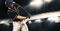 Porfessional baseball player with bat taking a swing on grand arena. Ballplayer on stadium in action. Royalty Free Stock Photo