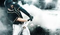 Porfessional baseball player with bat taking a swing on grand arena. Ballplayer on stadium in action. Royalty Free Stock Photo