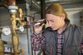 Porfessional plumber controling water quality from heater Royalty Free Stock Photo