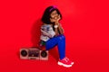 Porifle side view portrait of attractive cheerful girl sitting on retro tape player dj deejay rest evening isolated over