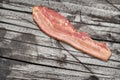 Pork Bacon Rasher on Old Weathered Cracked Wooden Garden Table