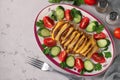 Pork baked with cheese served with vegetables on a plate, Top view