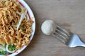 Pork ball stab in fork and instant noodle boiled on dish