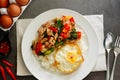 Pork basil leaves with fried egg on a plate of white rice and fr Royalty Free Stock Photo