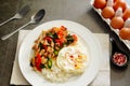 Pork basil leaves with fried egg on a plate of white rice and fr Royalty Free Stock Photo