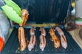 Pork and beef sausages made on an electric grill