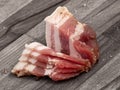 Pork belly meat, isolated on wooden board background. Lard piece isolated. Fresh meat brisket