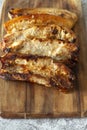 Pork belly pieces grilled cooked on a wooden chopping board.