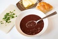 Pork blood soup with groats, butter, bun and chive on white Royalty Free Stock Photo