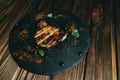 Pork bone steak on a board wooden background with honey kenzy, pepper
