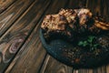 Pork bone steak on a wooden background with honey. Board slate. kenza, pepper Royalty Free Stock Photo