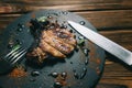 Pork bone steak on a wooden background with honey. Board slate. kenza, pepper Royalty Free Stock Photo