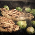 Pork and brussels sprouts on grill pan. Selective focus. Toned Royalty Free Stock Photo