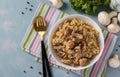 Pork with bulgur and champignons served in a white bowl, homemade hearty dish, Top view