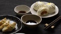 Pork buns and steamed Chinese dumpling with soy sauce Royalty Free Stock Photo