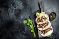 Pork carnitas tacos on corn tortillas with onion and lime. Black background. Top view. Copy space