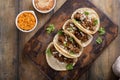 Pork carnitas tacos with onion and cilantro served with rice and refried beans