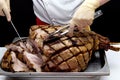 Pork. Chef cuts baked meat