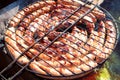 Pork and chicken sausages. Cooking on barbecue chargrill, brazier. Top view, closeup. Outdoors. Fast food. Preparation Royalty Free Stock Photo