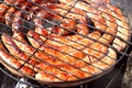 Pork and chicken sausages. Cooking on barbecue chargrill, brazier. Top view, closeup. Outdoors. Fast food. Preparation of sausages Royalty Free Stock Photo