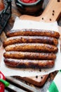 Pork chipolata. Close-up view of fried sausages. Meat dish