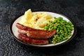 Pork Chipolata sausages with home cooked mashed potato and green peas