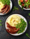 Pork Chipolata sausages with home cooked mashed potato and green peas Royalty Free Stock Photo
