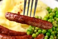 Pork Chipolata sausages with home cooked mashed potato and green peas