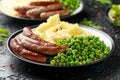 Pork Chipolata sausages with home cooked mashed potato and green peas