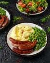 Pork Chipolata sausages with home cooked mashed potato and green peas