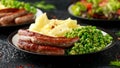 Pork Chipolata sausages with home cooked mashed potato and green peas