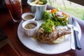 Pork chop served with mashed potatoes, salad and french fries. Royalty Free Stock Photo