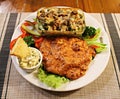 Pork chop with fresh vegetable salad and fried mushrooms with onions in a bowl Royalty Free Stock Photo