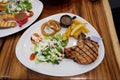 Pork chop with new potatoes, vegetables and gravy. Royalty Free Stock Photo