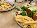 Pork chop sandwich, French fries, wild mushrooms and vegetables with hot chocolate