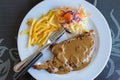 Pork chop steak with black pepper sauce, vegetables and french fries Royalty Free Stock Photo
