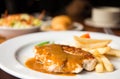 Pork chop with dilicious sauce and french fries Royalty Free Stock Photo