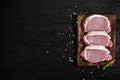 Roasted pork steaks fillet in frying pan over dark background, top view. Royalty Free Stock Photo